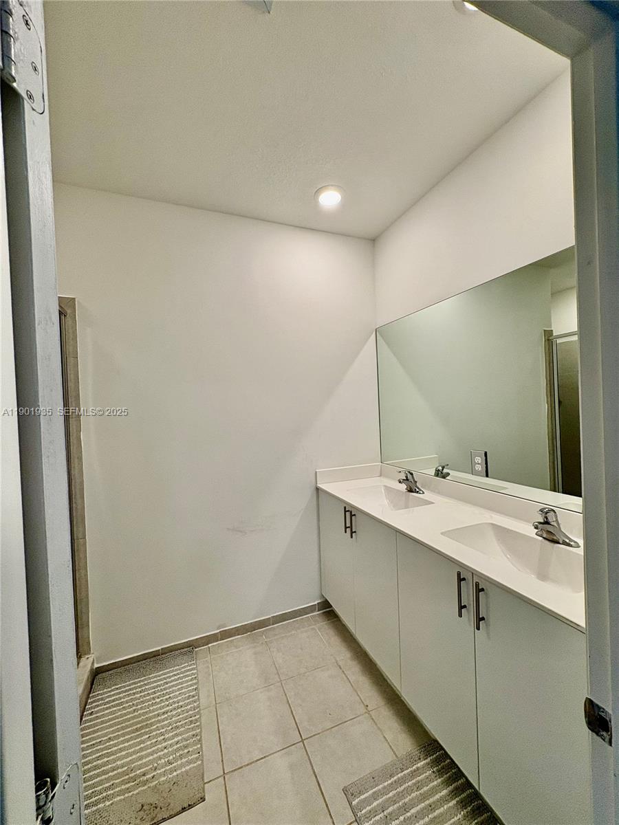 1020 Southeast 26th Street Homestead, FL 33035 - Photo 13 of 47 a bathroom with a double vanity sink and mirror