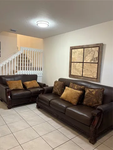a living room with a couch and a window