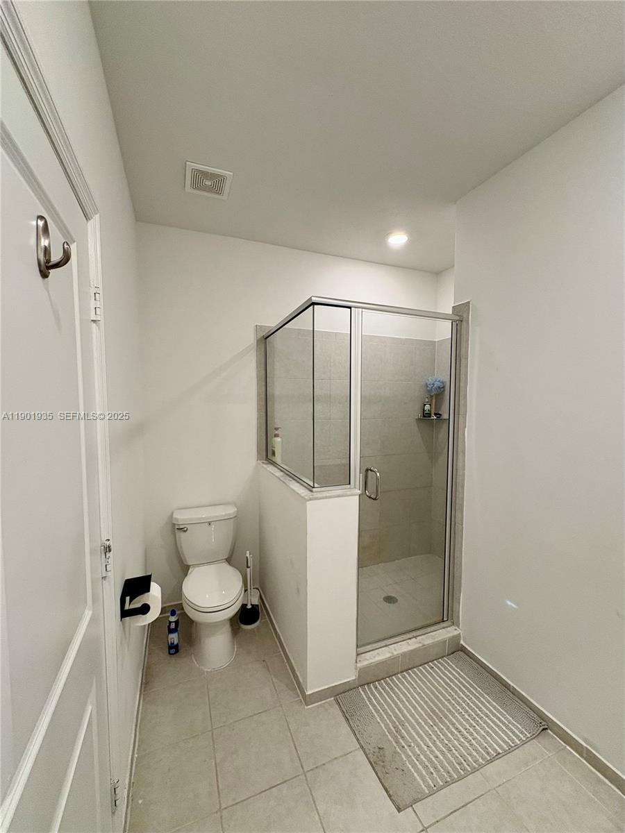 1020 Southeast 26th Street Homestead, FL 33035 - Photo 17 of 47 a bathroom with a granite countertop sink a toilet and shower