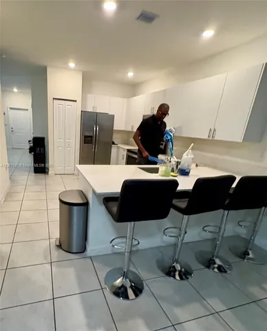 a dining room with furniture and a floor to ceiling window