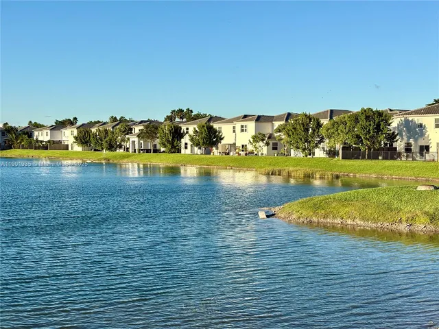 an aerial view of a houses with a lake view