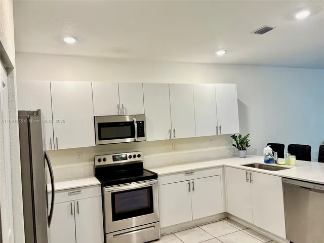 a kitchen with a sink stove and refrigerator