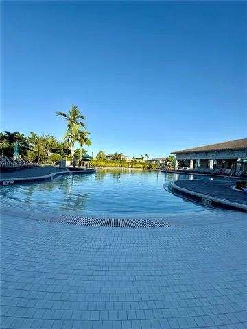 a view of a lake with lawn chairs