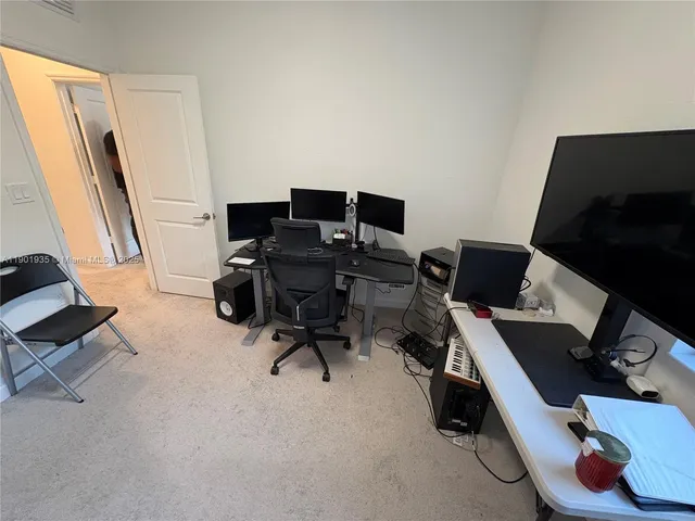 a view of workspace with wooden floor windows