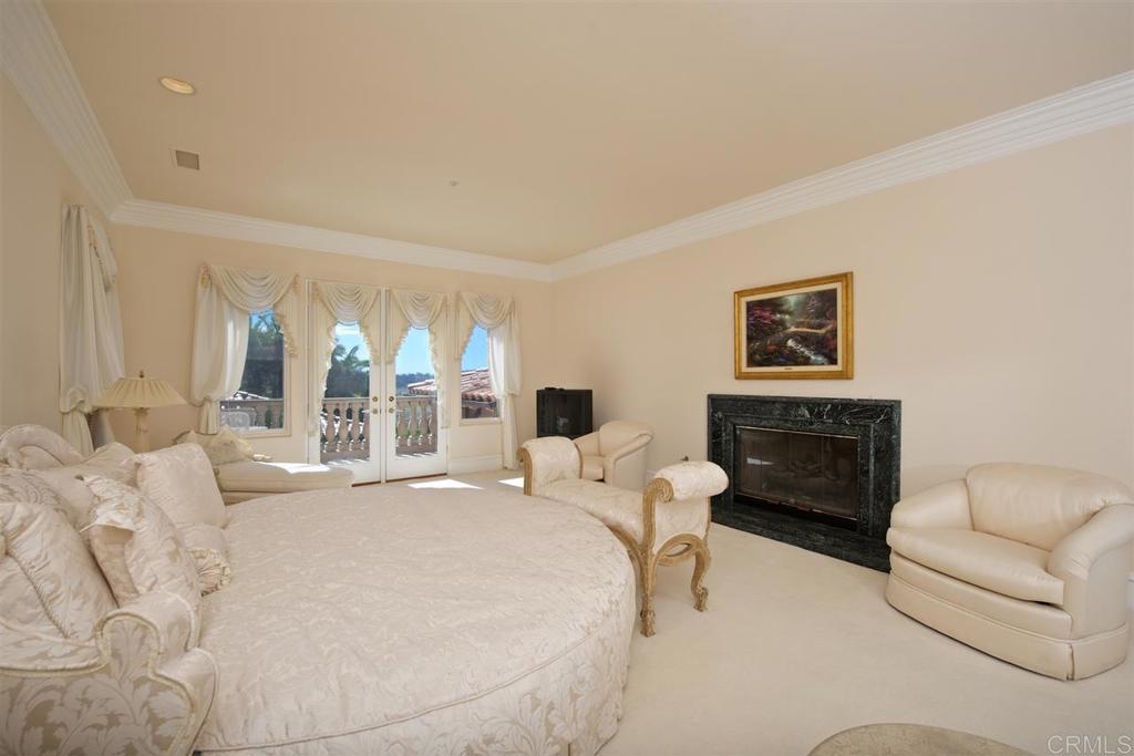 6827 Alydar Corte Del Mar, CA 92014 - Photo 12 of 24 a bedroom with a bed a couch and a large window