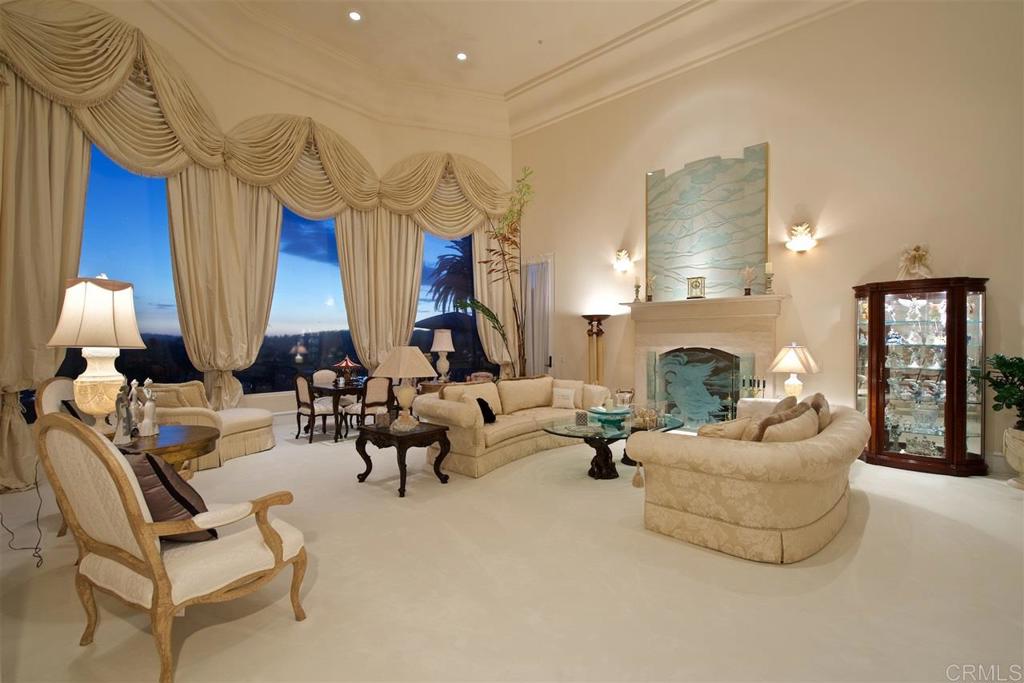 6827 Alydar Corte Del Mar, CA 92014 - Photo 4 of 24 a living room with furniture a fireplace and a chandelier