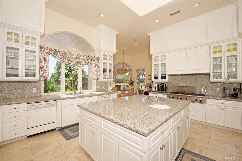 6827 Alydar Corte Del Mar, CA 92014 - Photo 5 of 24 a kitchen with granite countertop a sink a counter top space appliances and cabinets