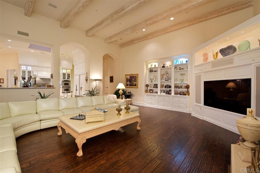 6827 Alydar Corte Del Mar, CA 92014 - Photo 7 of 24 a living room with furniture a fireplace and kitchen view