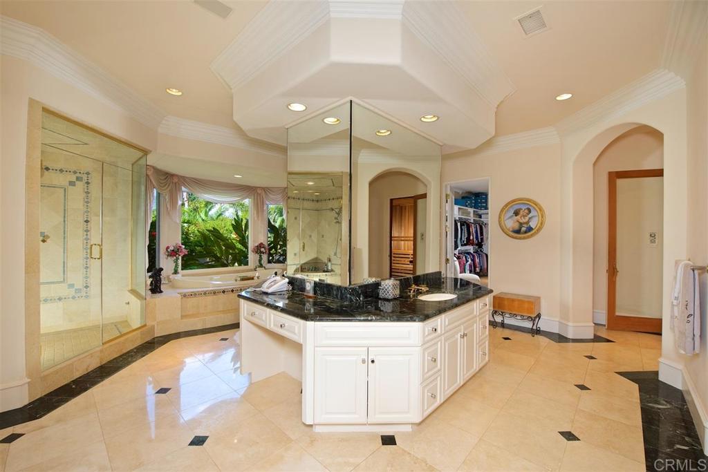 6827 Alydar Corte Del Mar, CA 92014 - Photo 10 of 24 a bathroom with a sink a large mirror and a bathtub