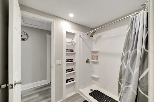 a bedroom with a bed and a table with wooden floor