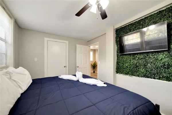 a bedroom with a bed and a flat screen tv