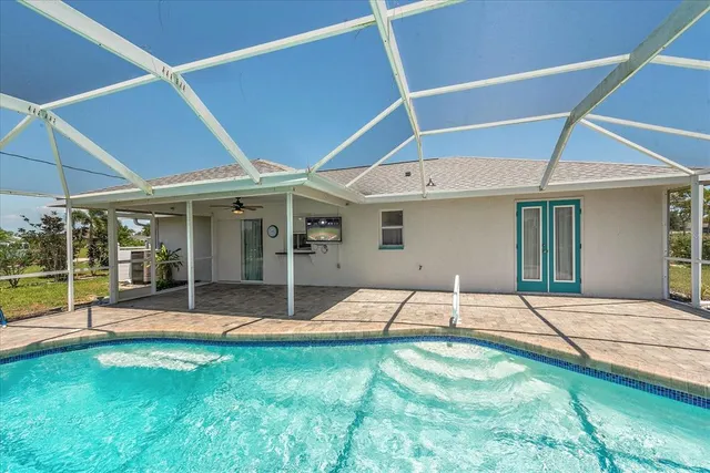 a backyard of a house with yard and outdoor seating