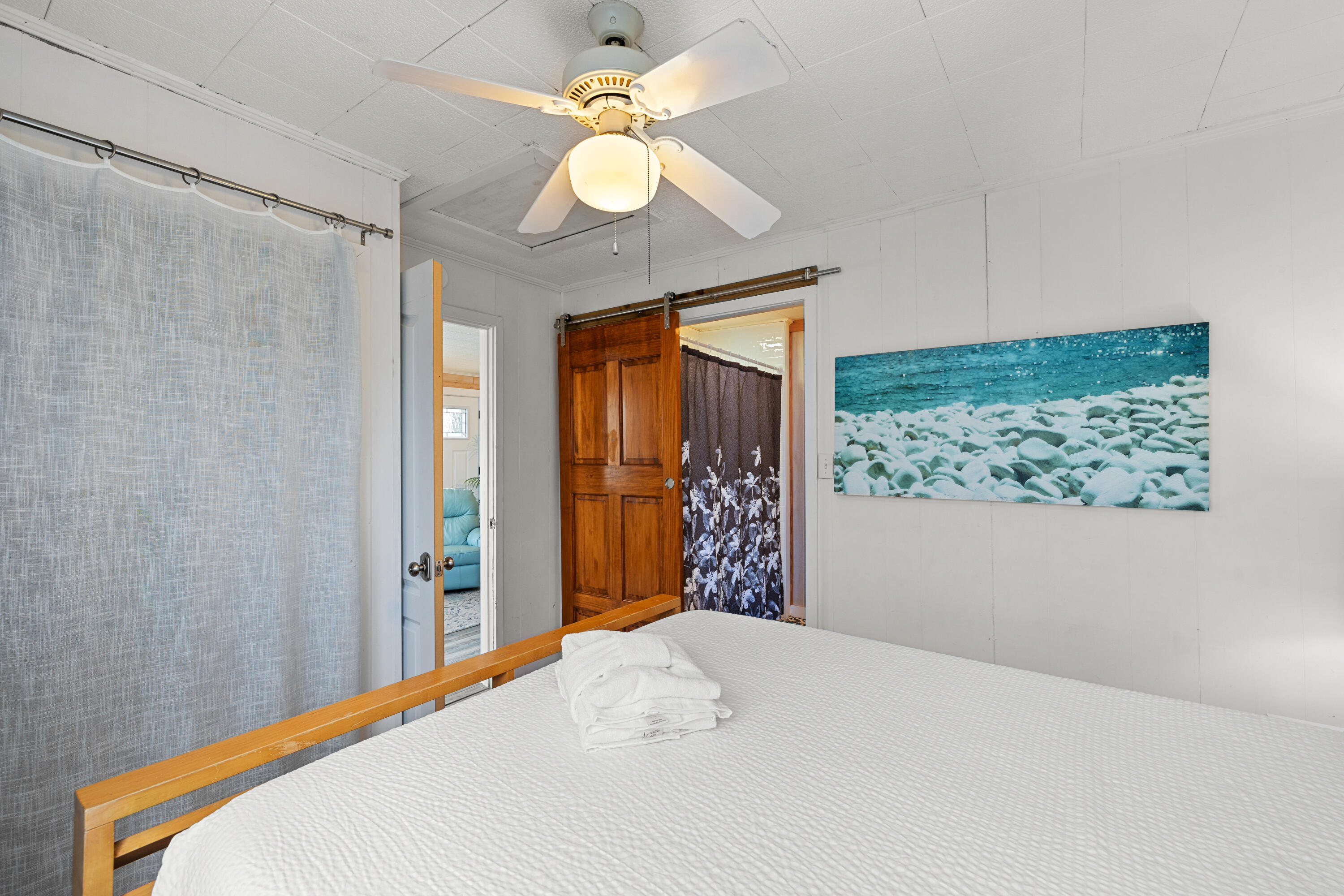 279 Robert Ellis Street Santa Rosa Beach, FL 32459 - Photo 10 of 29 a bedroom with a bed and a chandelier