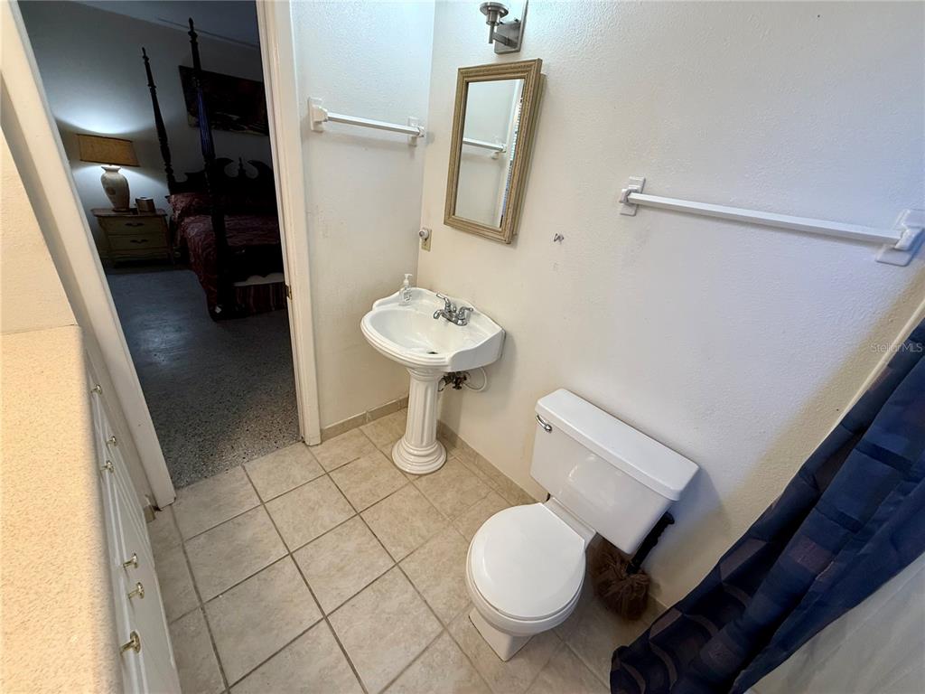 1004 Connecticut Road Tarpon Springs, FL 34689 - Photo 29 of 57 a bathroom with a sink and a mirror