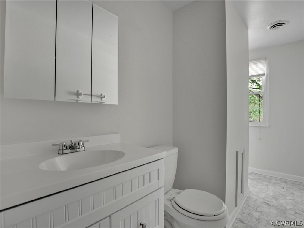 4131 Woodfield Road North Chesterfield, VA 23234 - Photo 15 of 20 a bathroom with a sink a toilet and vanity