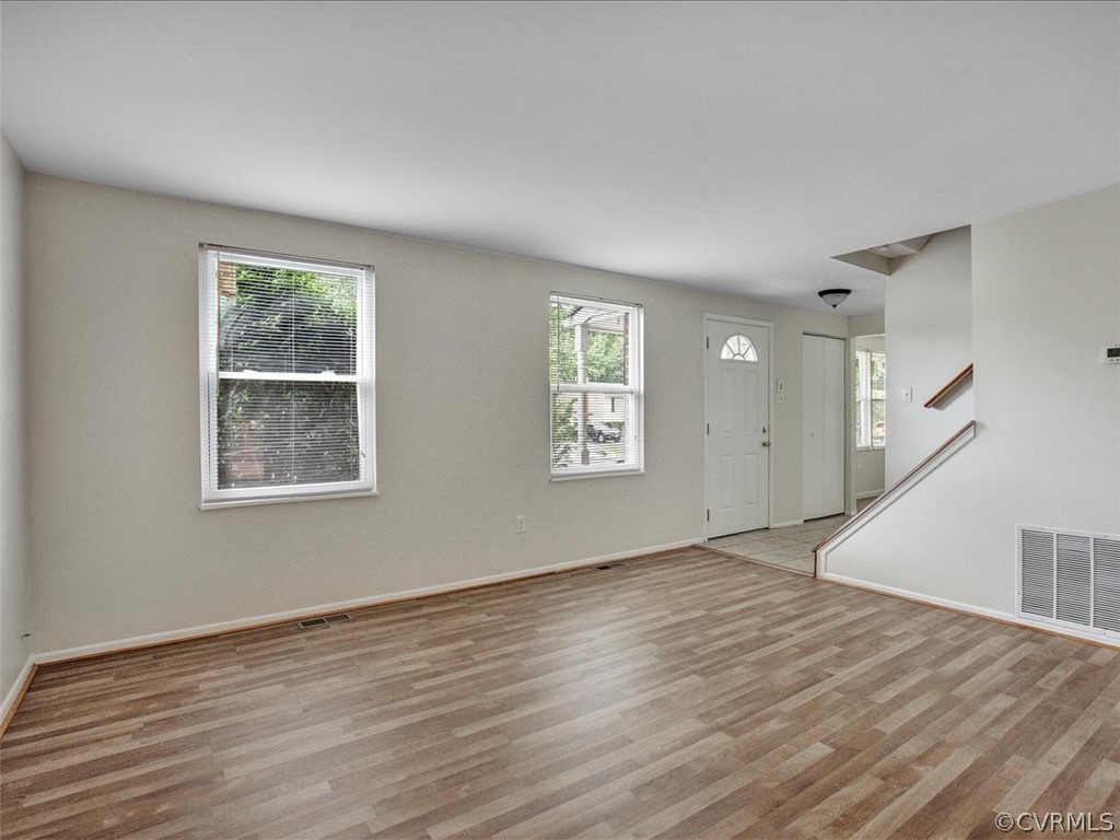 4131 Woodfield Road North Chesterfield, VA 23234 - Photo 6 of 20 a view of an empty room with wooden floor and a window
