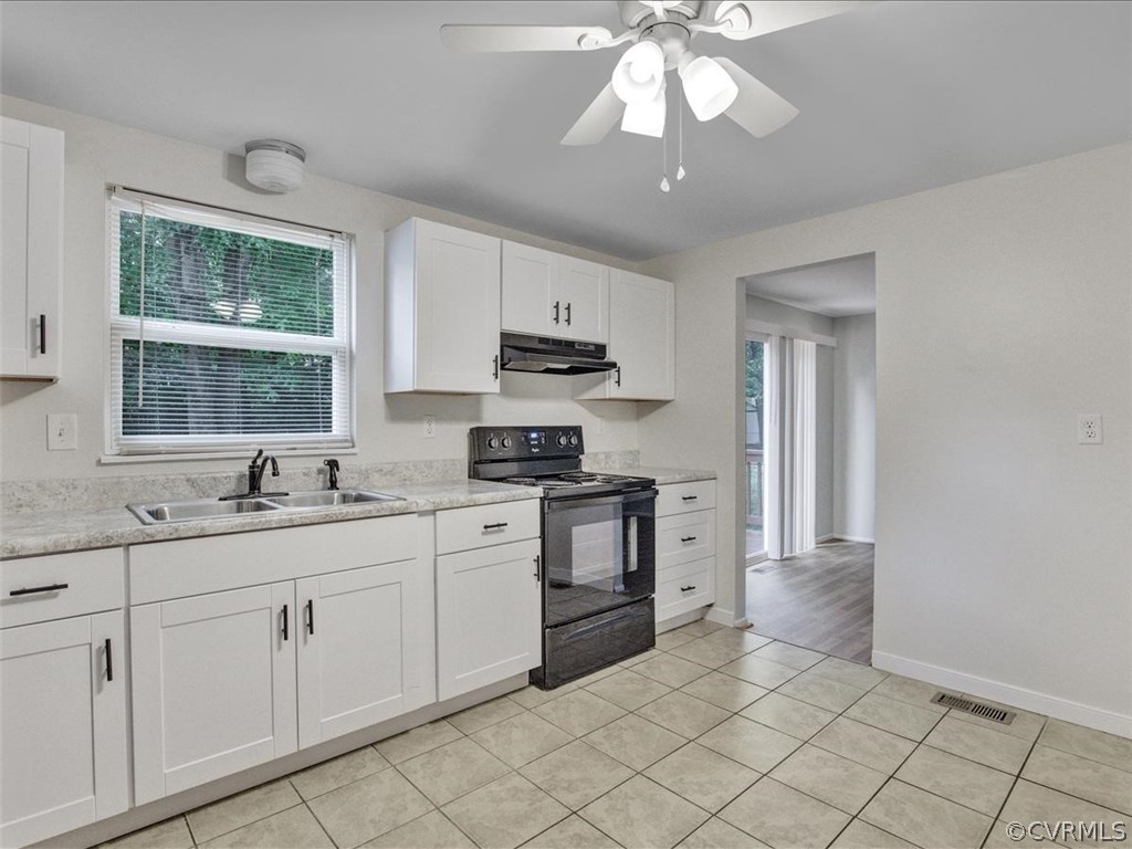 4131 Woodfield Road North Chesterfield, VA 23234 - Photo 8 of 20 a kitchen with white cabinets and appliances
