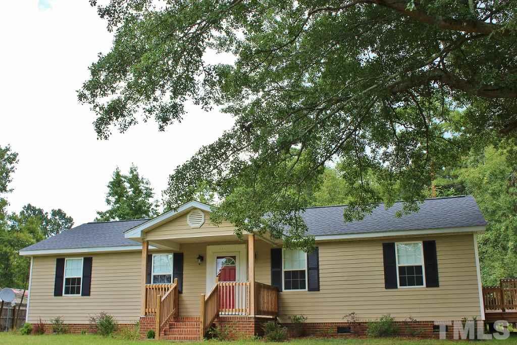 7360 Boykin Road Sims, NC 27880 - Photo 1 of 4 a front view of a house with garden