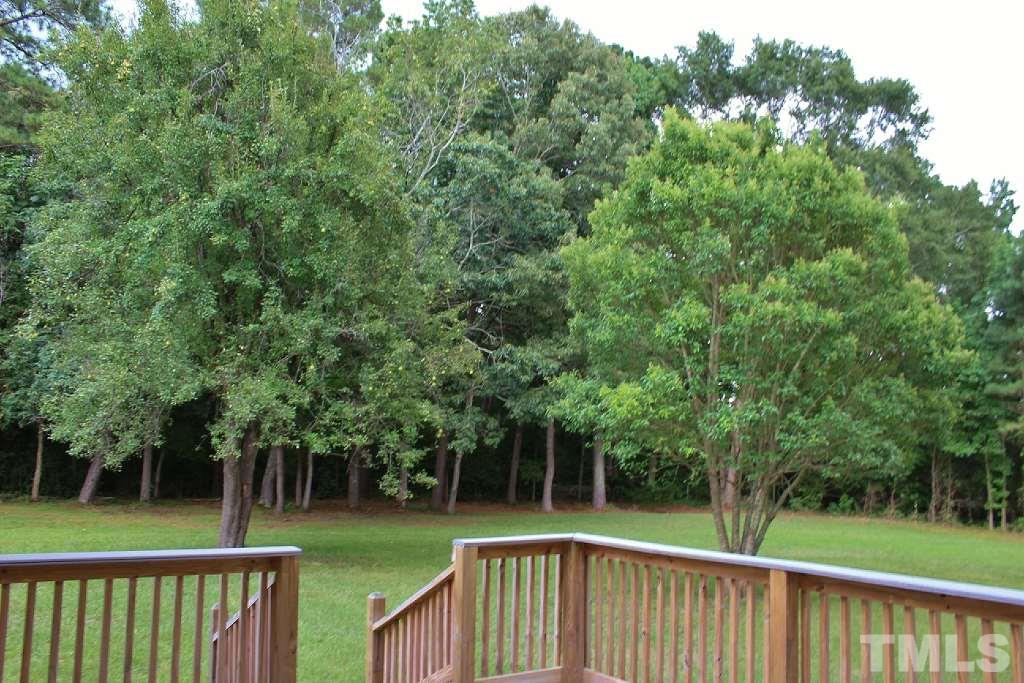 7360 Boykin Road Sims, NC 27880 - Photo 3 of 4 a view of a wooden deck and a forest