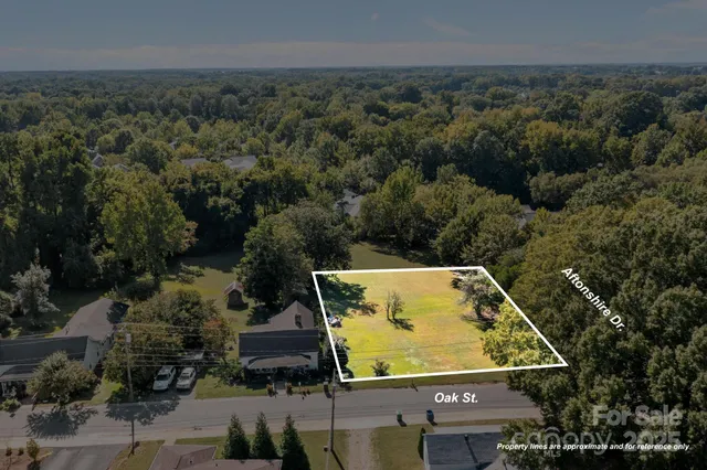 an aerial view of a residential houses with yard