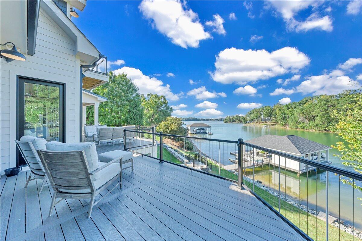 176 Three Point Isle Drive Penhook, VA 24137 - Photo 38 of 97 a view of a balcony with wooden floor and iron stairs