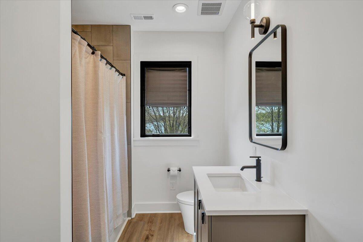 176 Three Point Isle Drive Penhook, VA 24137 - Photo 65 of 97 a bathroom with a sink and a mirror