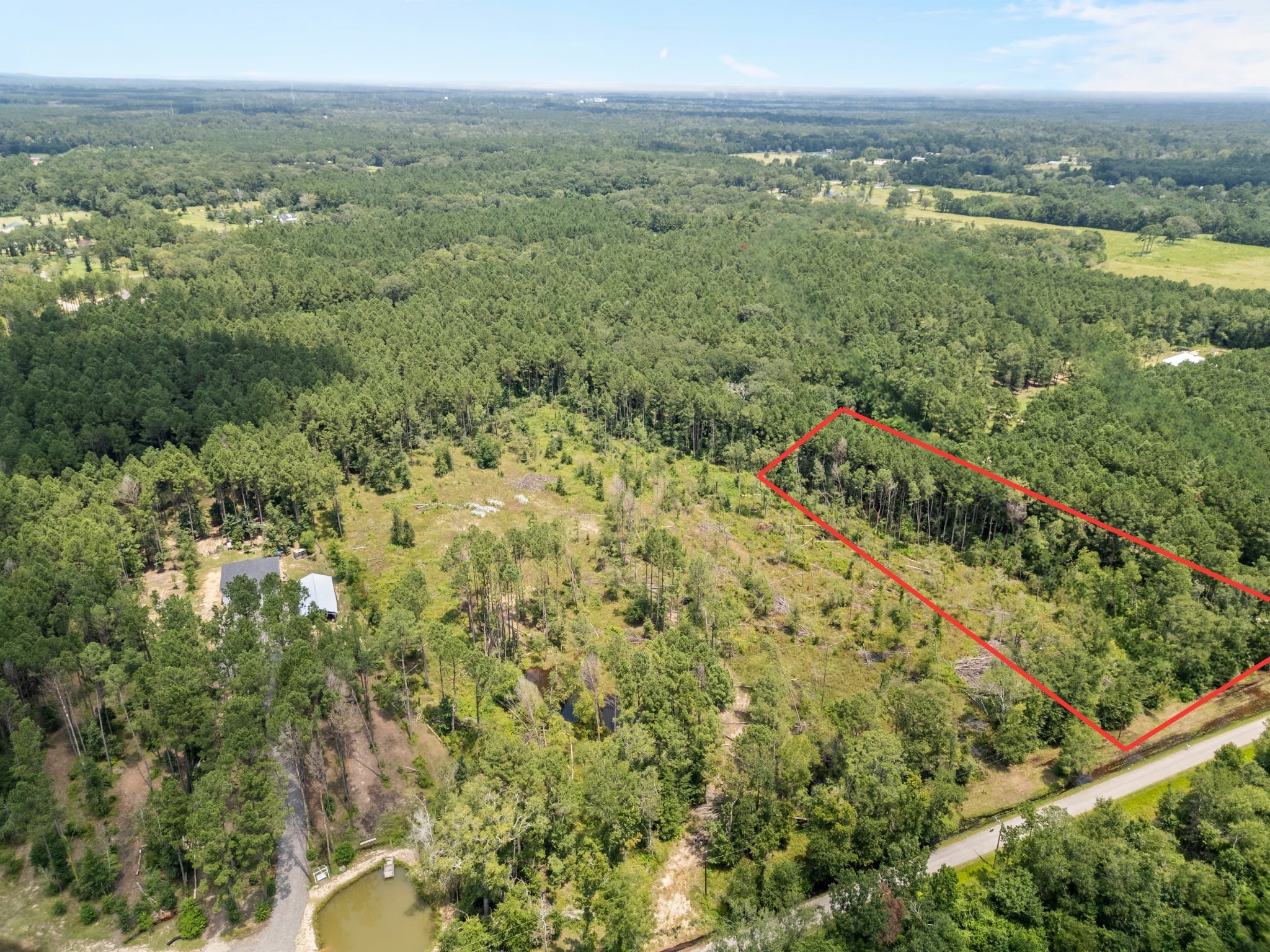 Tbd Pelican Road Shepherd, TX 77371 - Photo 5 of 7 a view of a city with lush green forest