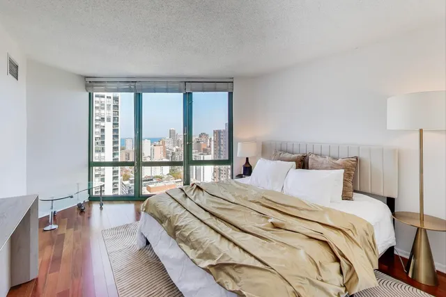 a bedroom with a large bed and a large window