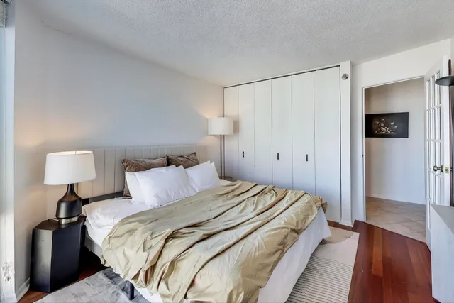 a bedroom with a bed and a lamp