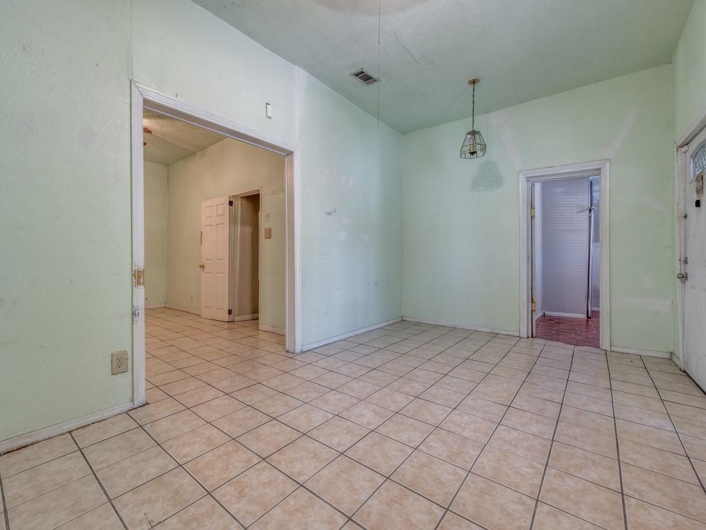 4942 Terry Street Dallas, TX 75223 - Photo 7 of 25 Empty room with visible vents and light tile patterned floors