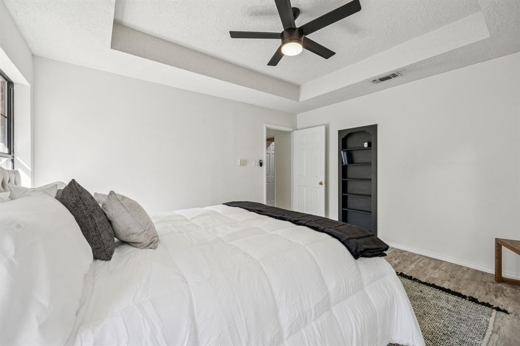 2900 Christopher Drive Denton, TX 76209 - Photo 11 of 25 a bedroom with a bed and a ceiling fan