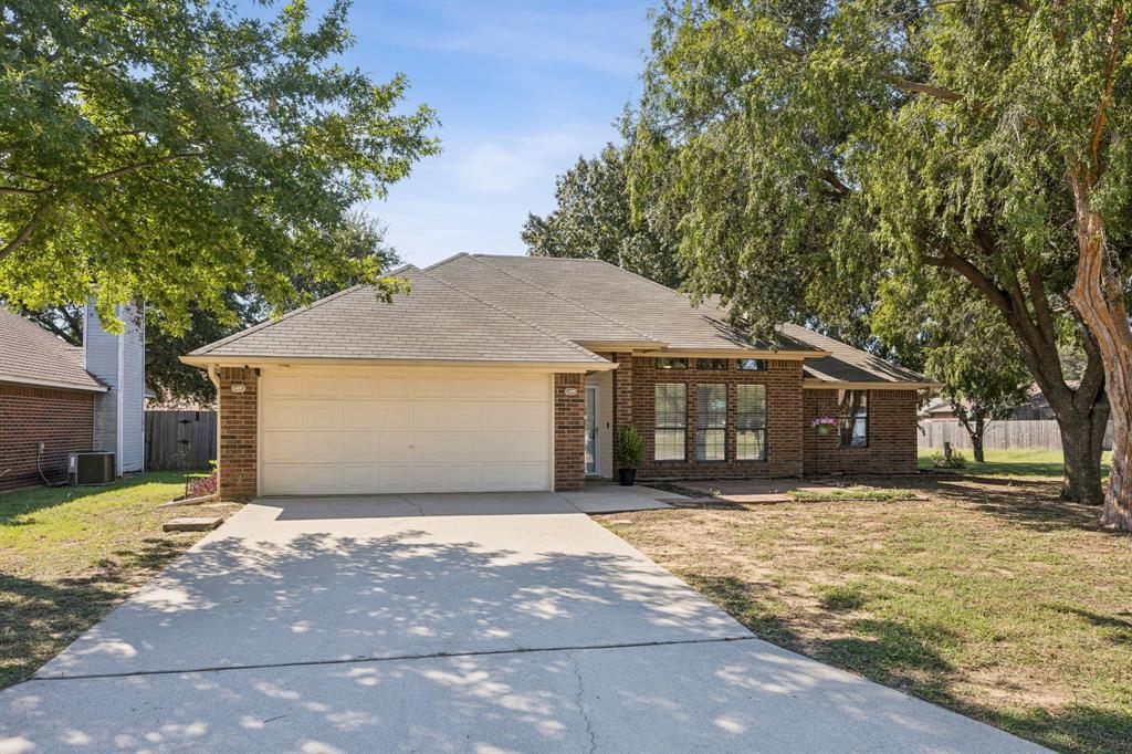 2900 Christopher Drive Denton, TX 76209 - Photo 20 of 25 a front view of a house with a yard and garage