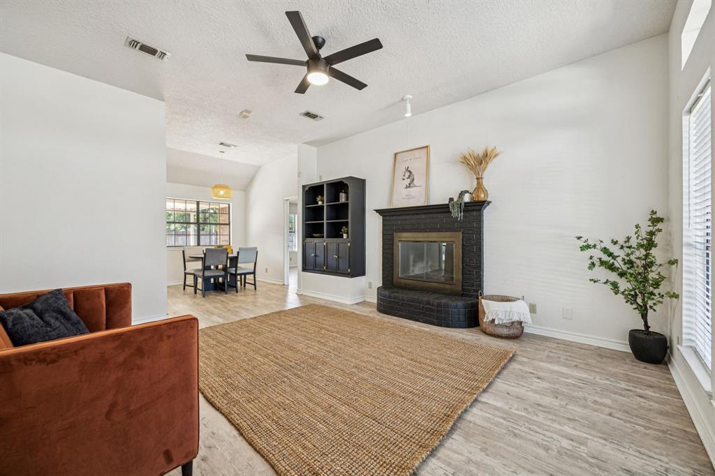 2900 Christopher Drive Denton, TX 76209 - Photo 2 of 25 a living room with furniture and a fireplace