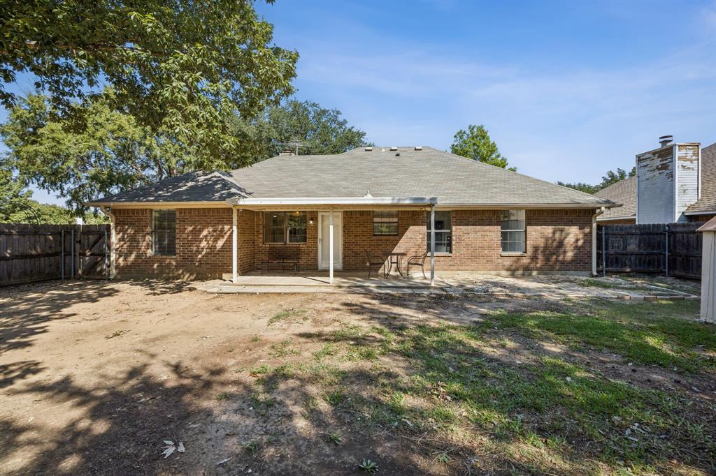 2900 Christopher Drive Denton, TX 76209 - Photo 23 of 25 a front view of a house with a garden