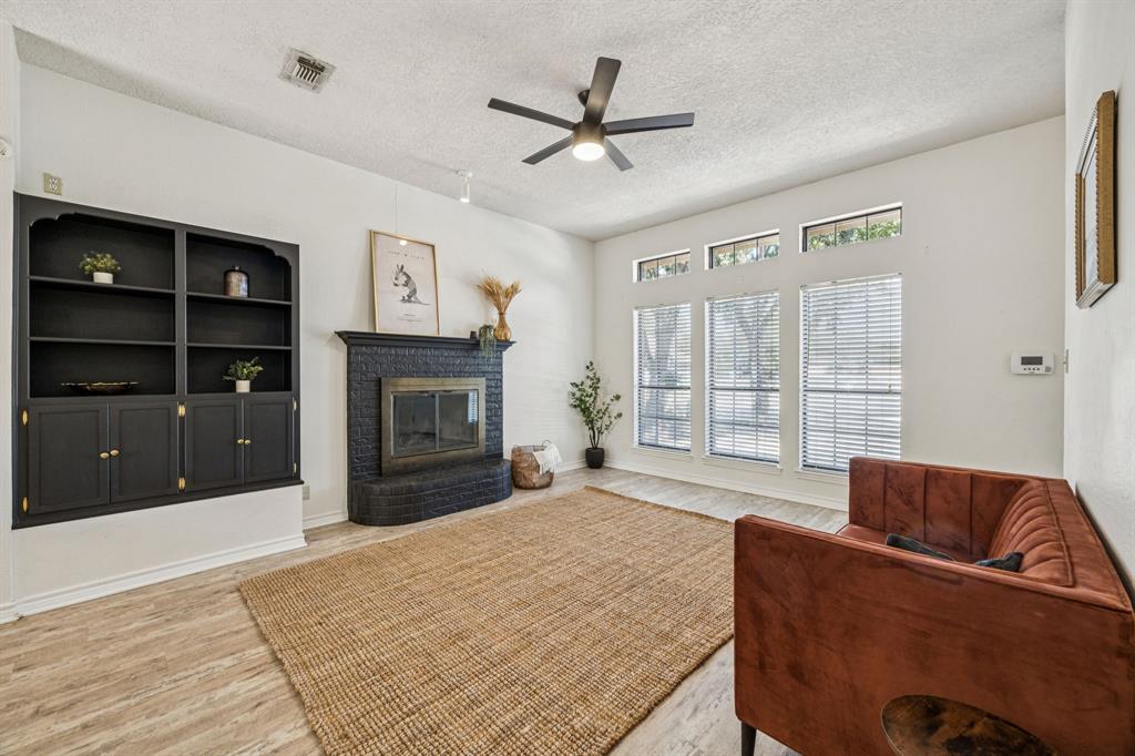 2900 Christopher Drive Denton, TX 76209 - Photo 4 of 25 a living room with furniture and a fireplace
