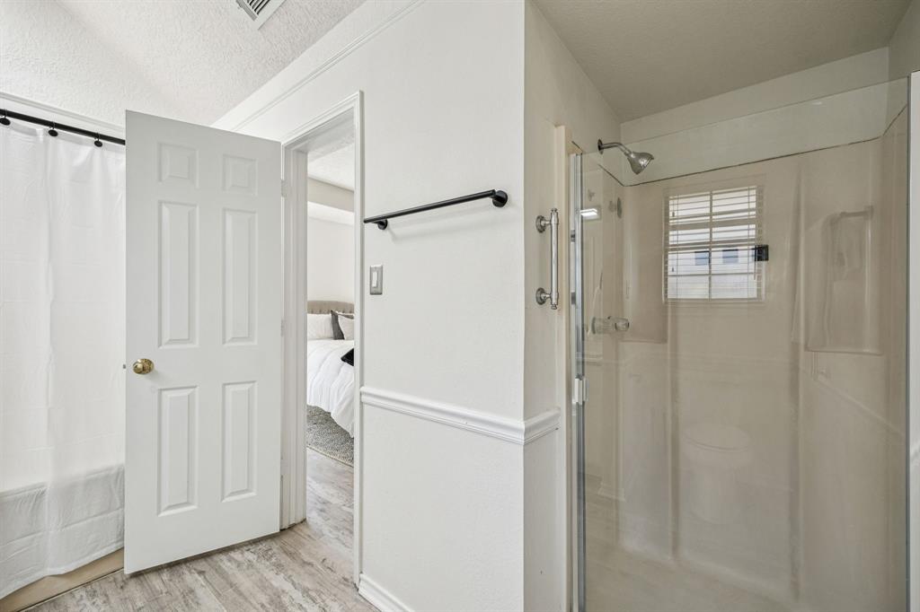 2900 Christopher Drive Denton, TX 76209 - Photo 8 of 25 a bathroom with a shower and a glass door
