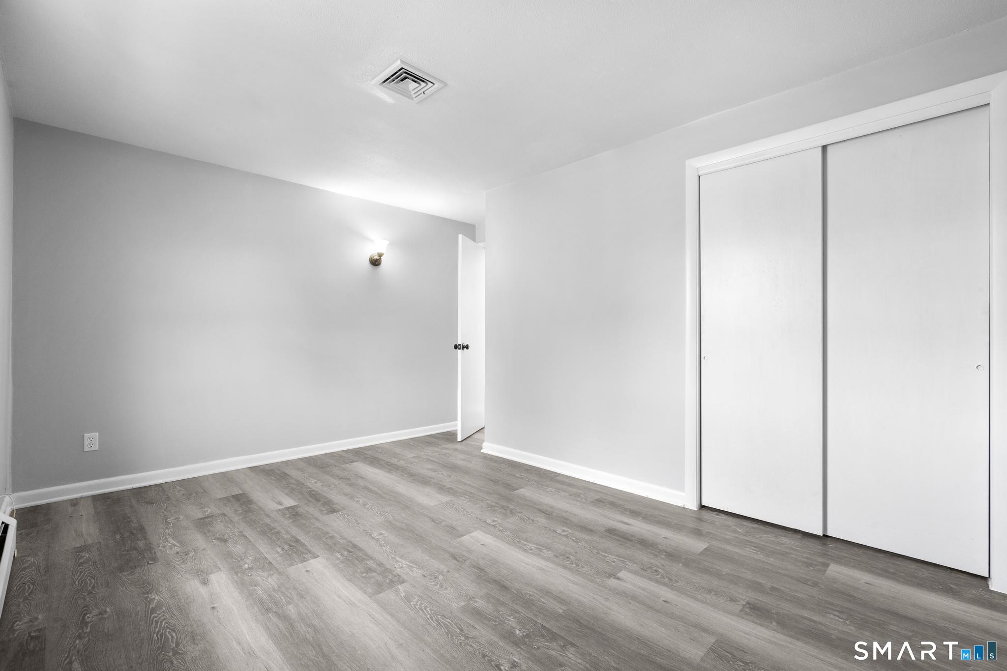 13 Allen Street Bristol, CT 06010 - Photo 21 of 40 a view of an empty room with wooden floor