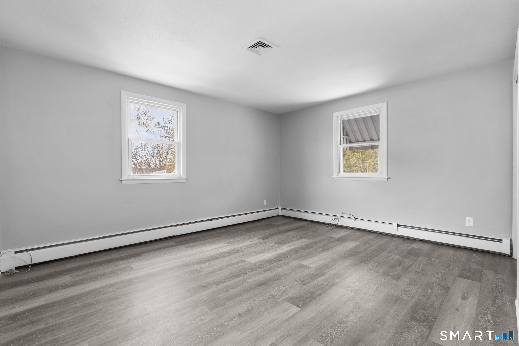 13 Allen Street Bristol, CT 06010 - Photo 23 of 40 a view of an empty room with wooden floor and a window