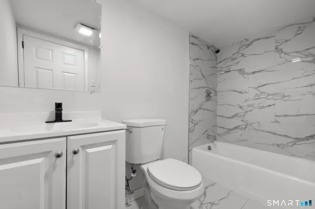 a bathroom with a bathtub and shower