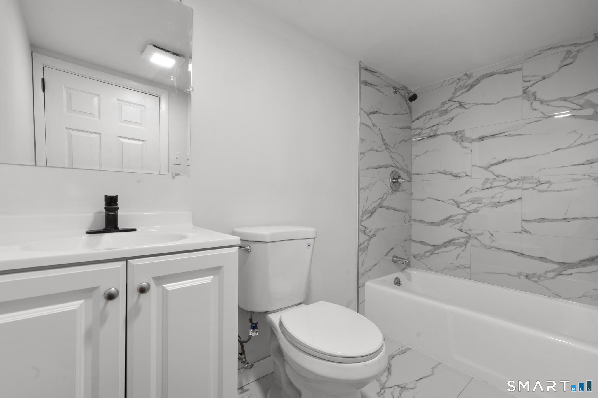 13 Allen Street Bristol, CT 06010 - Photo 27 of 40 a bathroom with a sink a toilet and shower