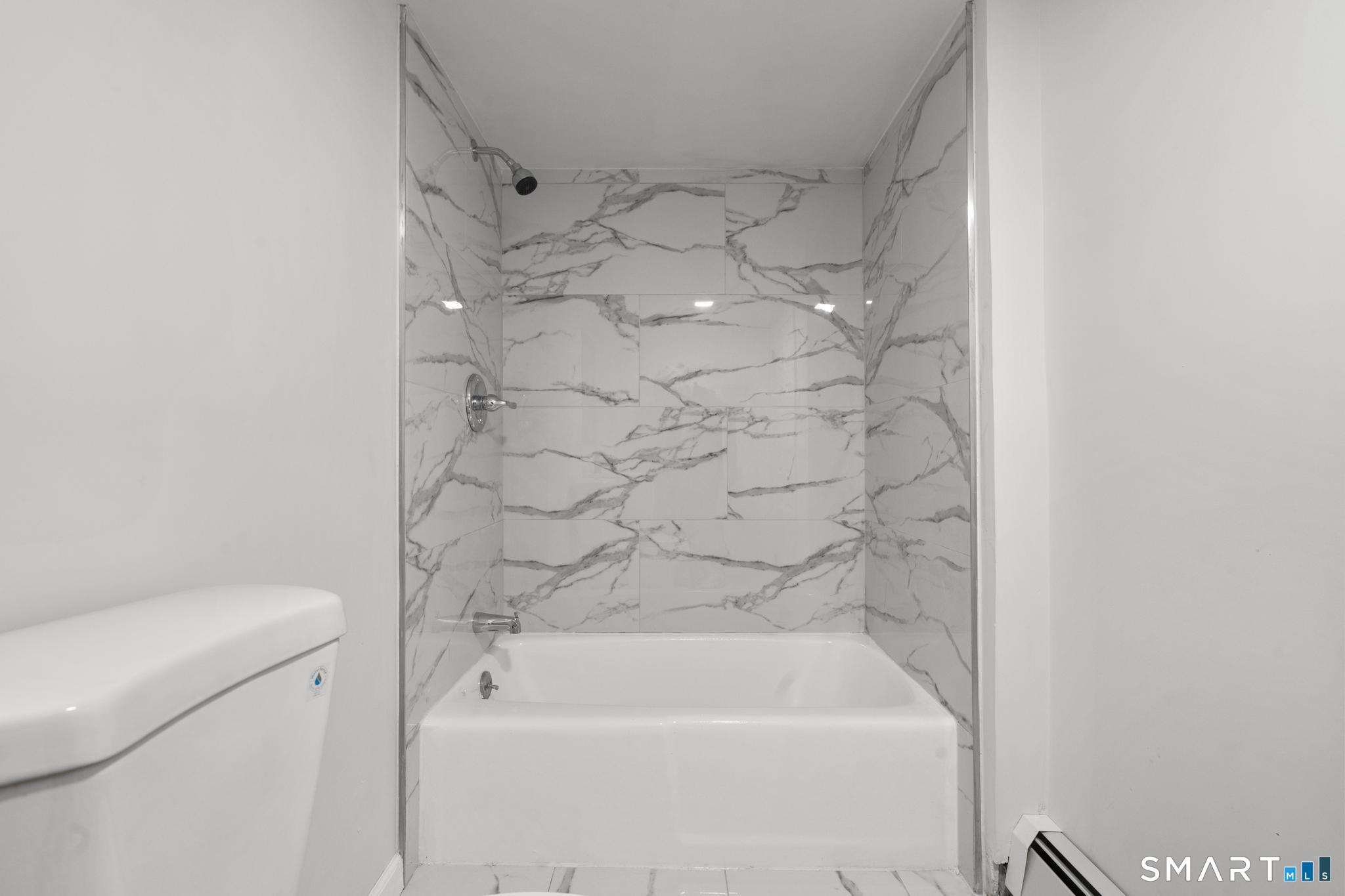 13 Allen Street Bristol, CT 06010 - Photo 28 of 40 a bathroom with a bathtub and shower