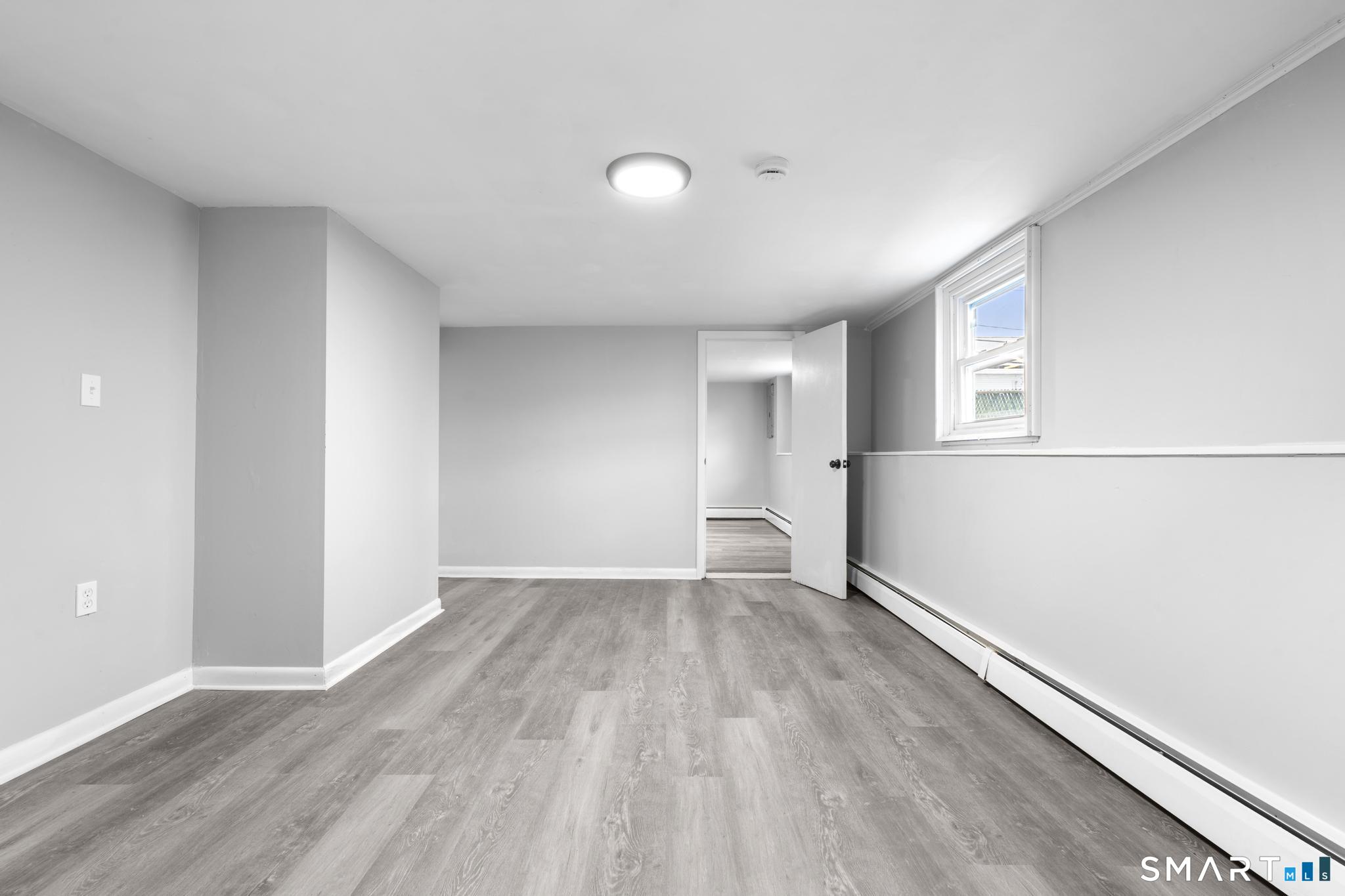 13 Allen Street Bristol, CT 06010 - Photo 29 of 40 an empty room with wooden floor and windows