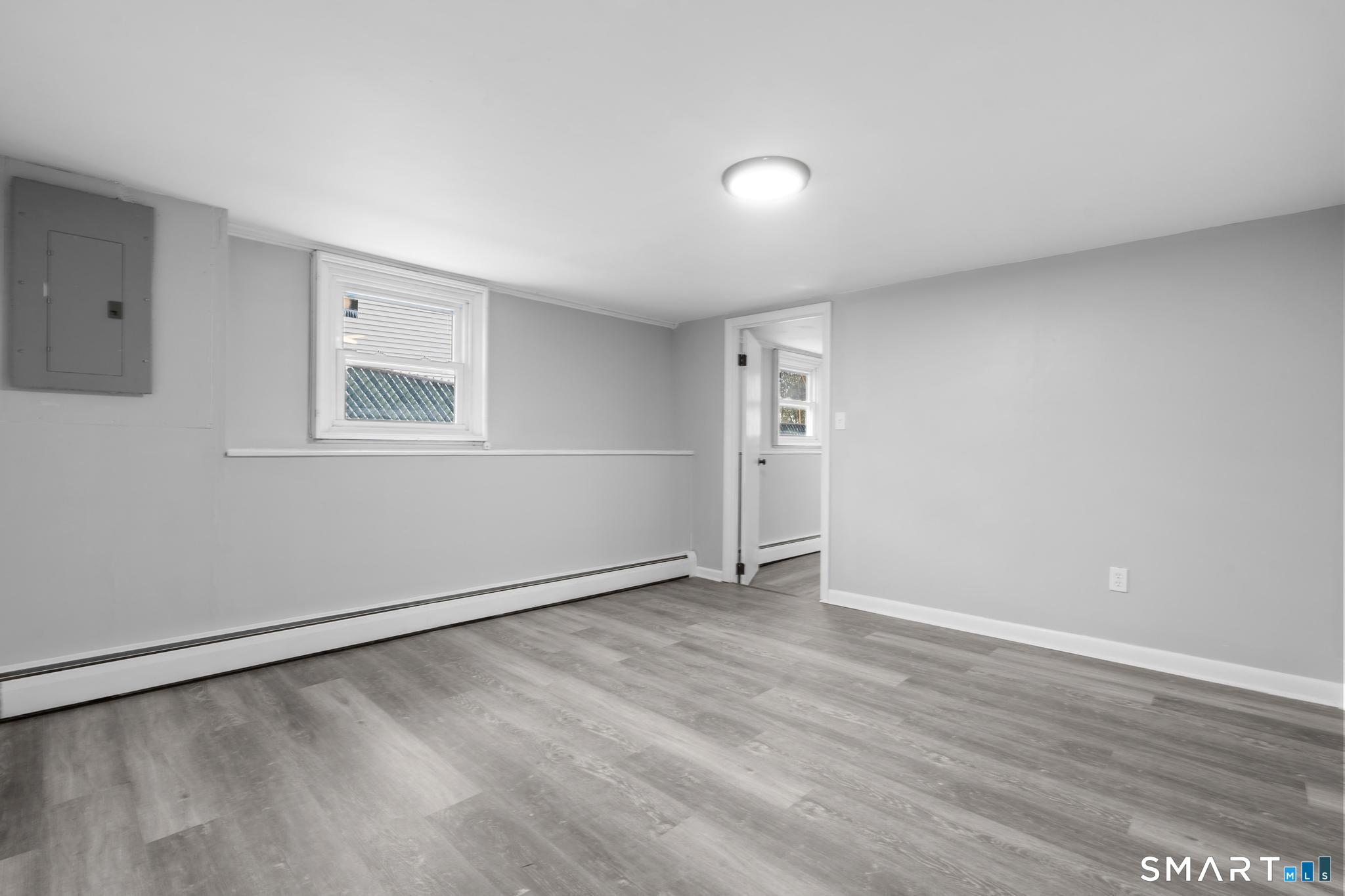 13 Allen Street Bristol, CT 06010 - Photo 35 of 40 an empty room with wooden floor and windows