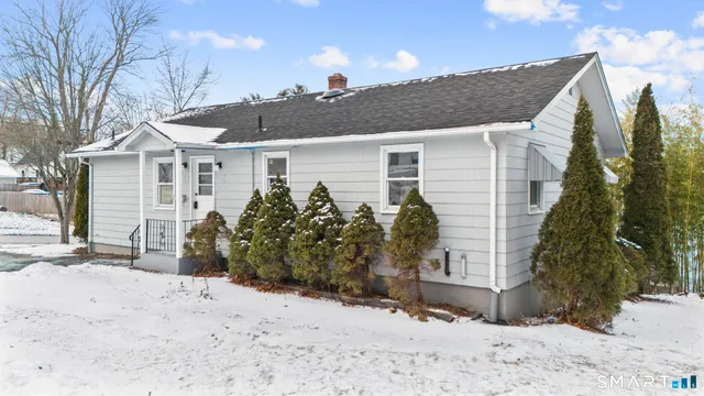 a view of a house with a snow in the background