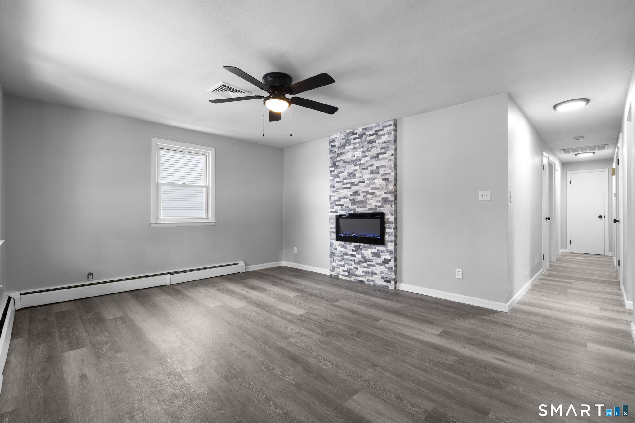 13 Allen Street Bristol, CT 06010 - Photo 7 of 40 a view of an empty room with wooden floor and a window