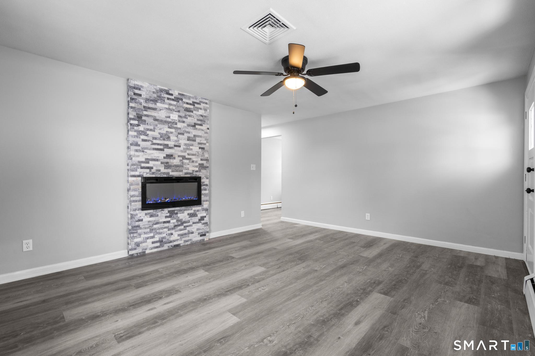 13 Allen Street Bristol, CT 06010 - Photo 9 of 40 a view of an empty room with window and wooden floor