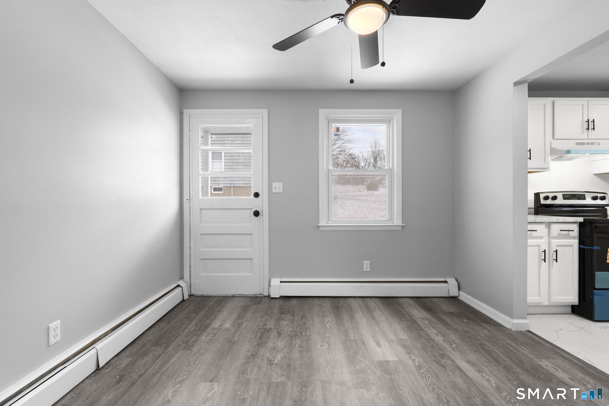 13 Allen Street Bristol, CT 06010 - Photo 10 of 40 an empty room with wooden floor cabinet and windows