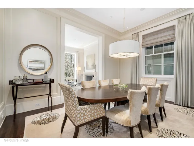 a kitchen with stainless steel appliances a sink a stove and white cabinets