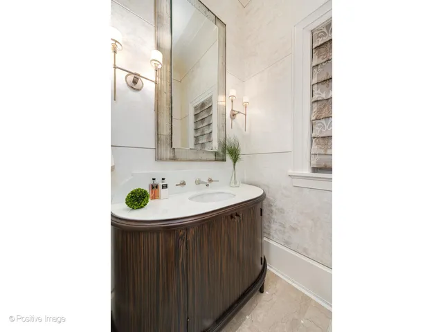 a kitchen with kitchen island a stove a sink and a refrigerator