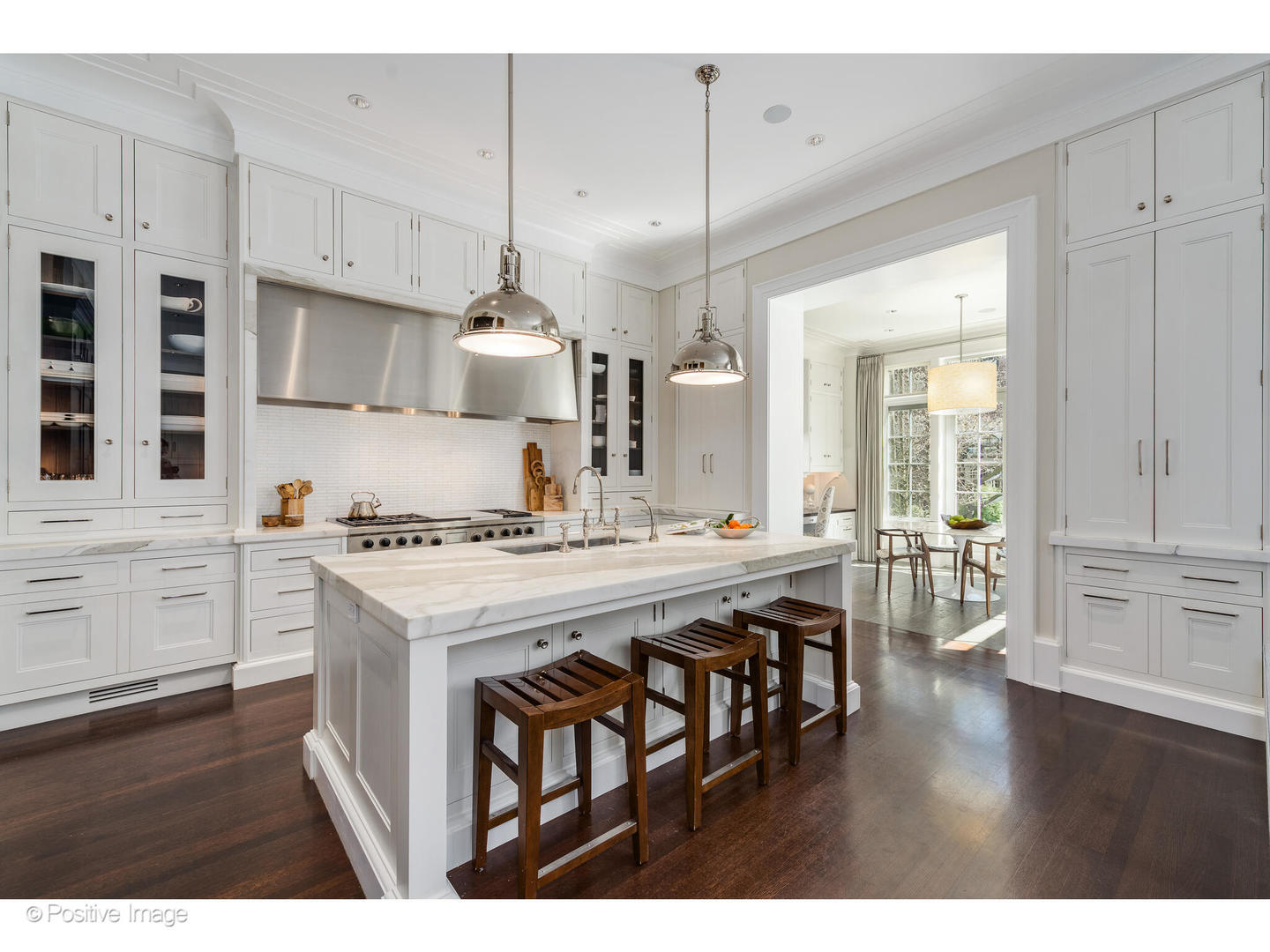 1853 North Burling Street Chicago, IL 60614 - Photo 22 of 86 a kitchen with wooden floor and white cabinets